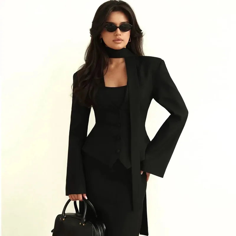 Woman wearing a black coat and dress with sunglasses on a white background