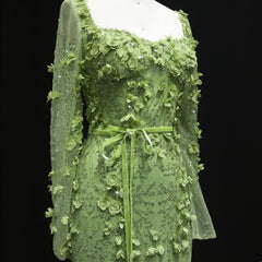 Green lace dress on a mannequin against a black background