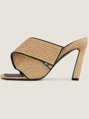 Side profile of woven square toe heeled slippers