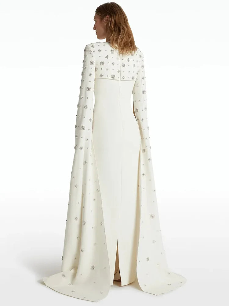 Back view of white maxi dress with beaded cape sleeves