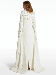 Back view of white maxi dress with beaded cape sleeves
