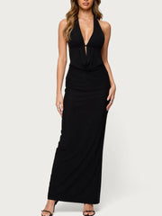 Black halter neck dress worn by a model on a white background