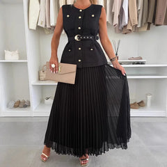 Woman wearing a black sleeveless top with buttons and a pleated black skirt, holding a beige handbag in a clothing store.