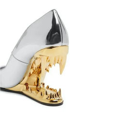Metallic high-heeled shoe with gold and silver design on a white background