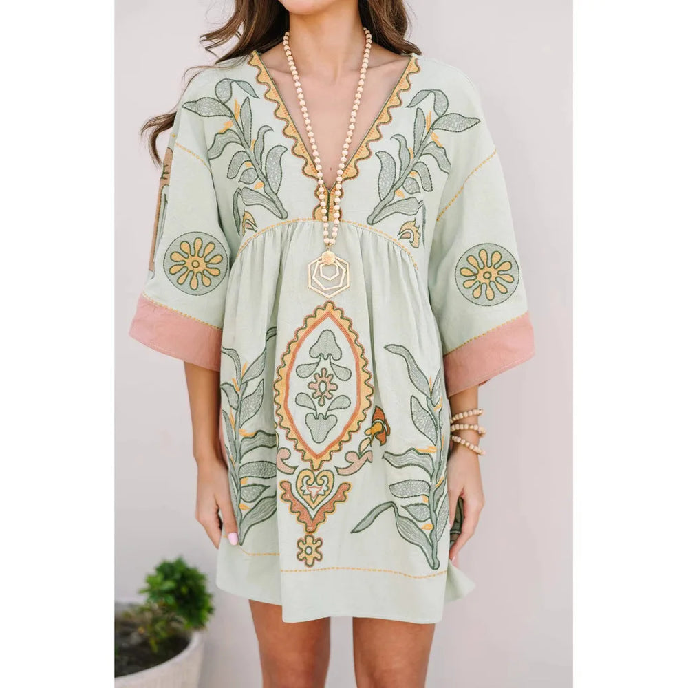 Light green mini dress with floral embroidery and pink trim
