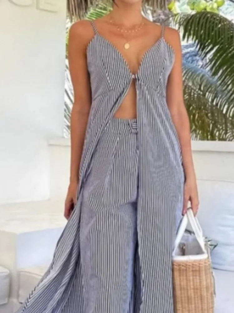 Woman wearing a blue and white striped dress with a blurred outdoor background