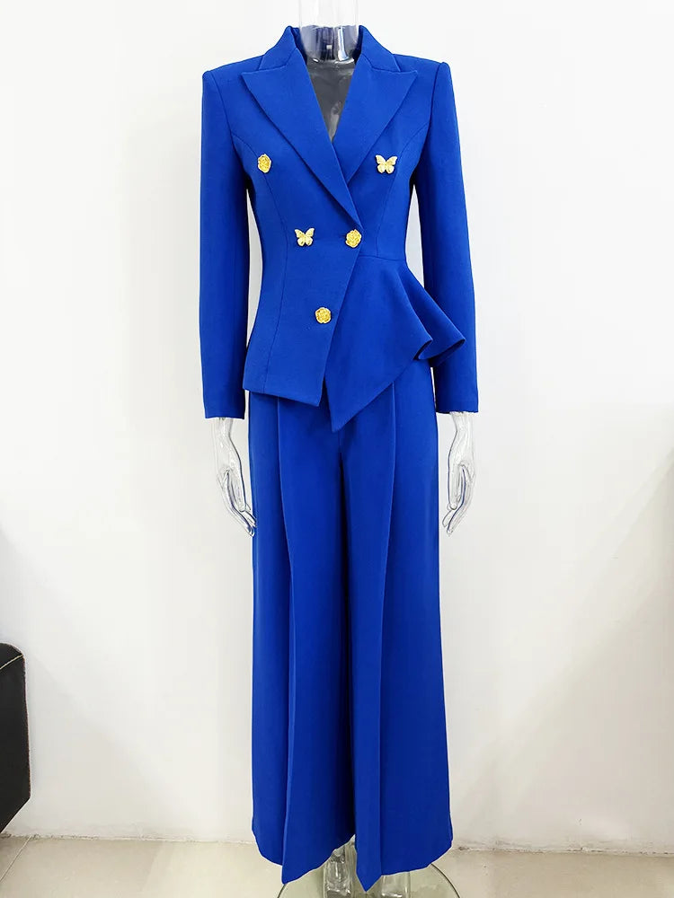 Blue blazer suit with asymmetrical peplum and flare pants displayed on a mannequin.