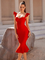 Woman in a red dress standing outdoors with classical architecture in the background