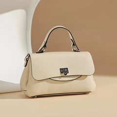Beige handbag with a visible brand logo on a beige background