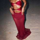 Cutout detail embellished one-piece and sheer skirt swimwear set on sand