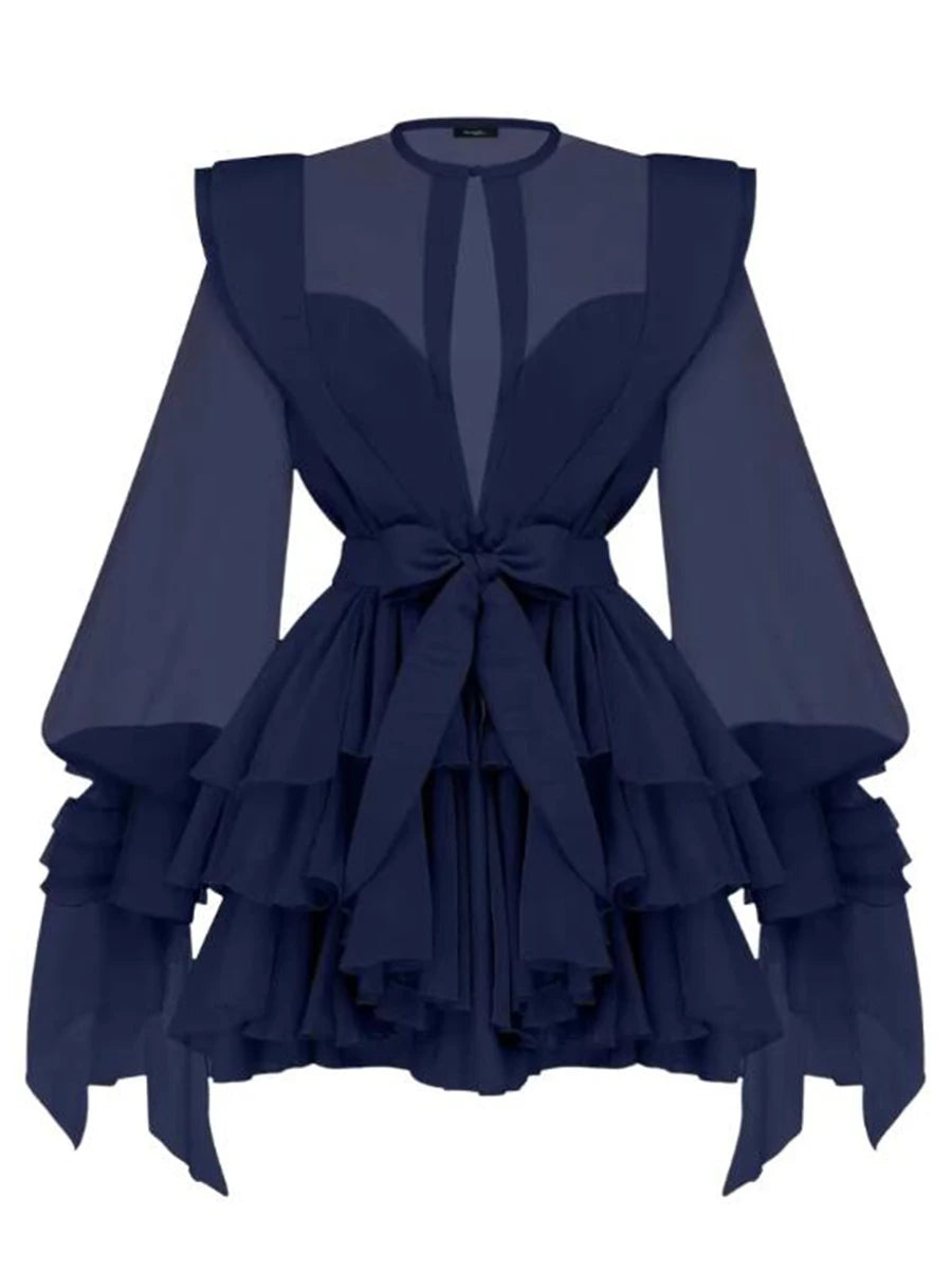 Navy blue dress with ruffled layers and sheer sleeves on a white background