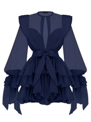 Navy blue dress with ruffled layers and sheer sleeves on a white background