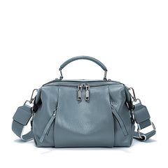 Gray handbag with multiple straps on a white background