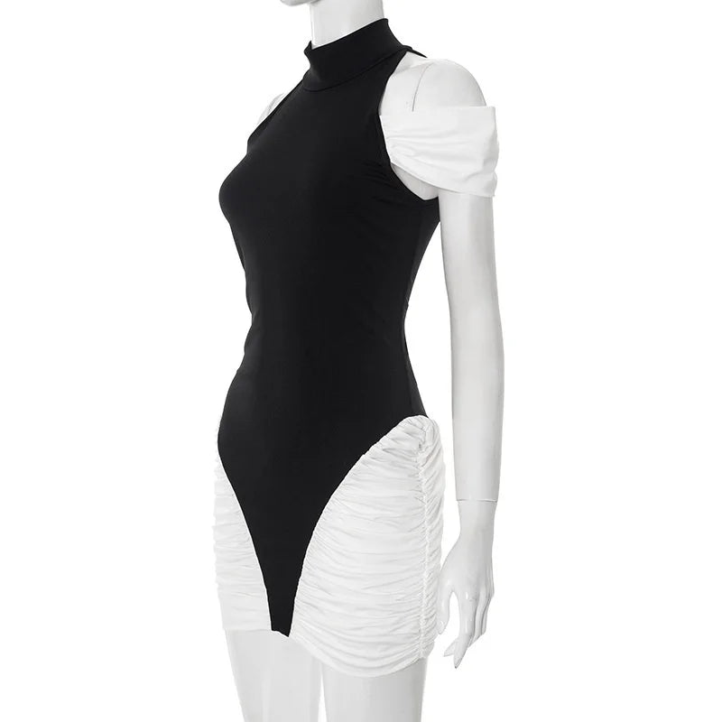 Mannequin wearing a black and white dress with a high neckline and ruffled white bottom half on a white background.