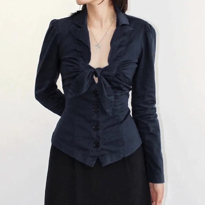 Black top with a knot detail on a plain background