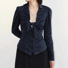 Black top with a knot detail on a plain background