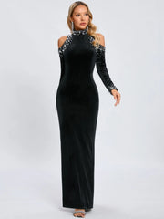 Black evening gown with long sleeves and embellishments on a white background