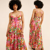 Woman wearing a colorful floral dress, front and back views, on a beige background