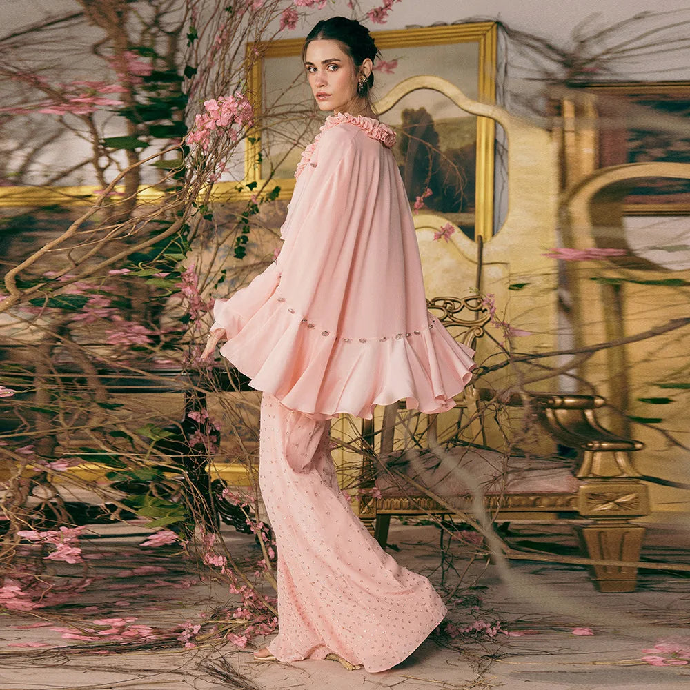 Pastel ruffled cape V-neck crop top with embellished flare trousers, side view