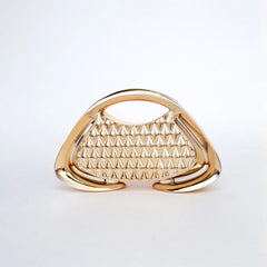Gold handbag with pyramid pattern on a light gray background