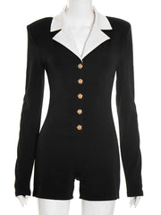 Black riding jacket with white collar and gold buttons on a mannequin against a white background