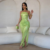 Woman wearing green metallic 2-piece set in modern lounge