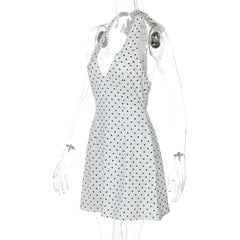 White dress with black polka dots on a mannequin against a white background