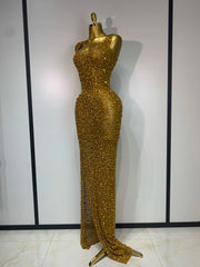 Side view of a gold diamond-embellished maxi dress on a mannequin