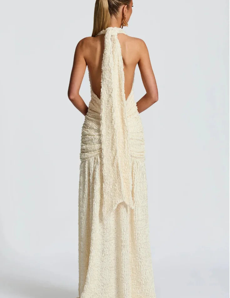 Woman wearing a long, elegant dress with a white background