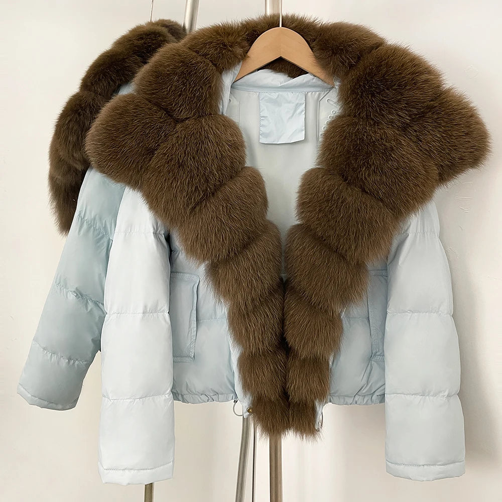 Light blue puffer jacket with brown fur collar on a hanger against a white background