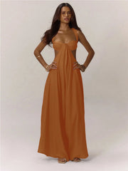 Woman wearing a long orange jumpsuit against a white background