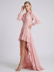 Detail of ruffled hem on pink high-low dress