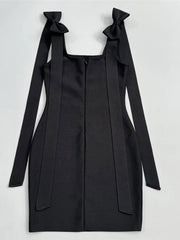 Black dress with bow straps on a white background