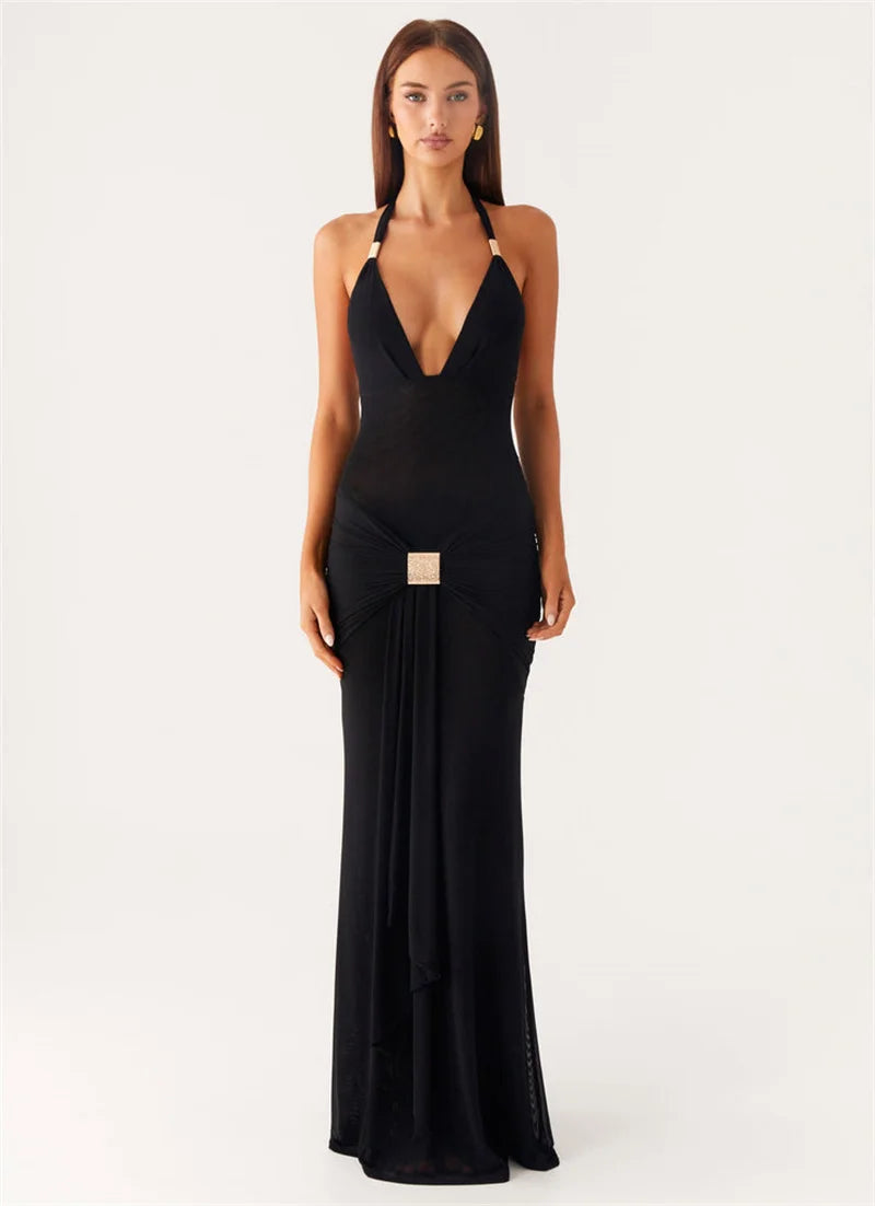 Woman wearing a black halter neck gown on a white background
