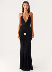 Woman wearing a black halter neck gown on a white background