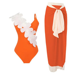 Orange one-piece swimsuit with white floral embellishment and an orange wrap skirt with white trim.