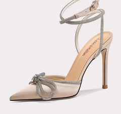 High-heeled shoe with decorative bow on a white background