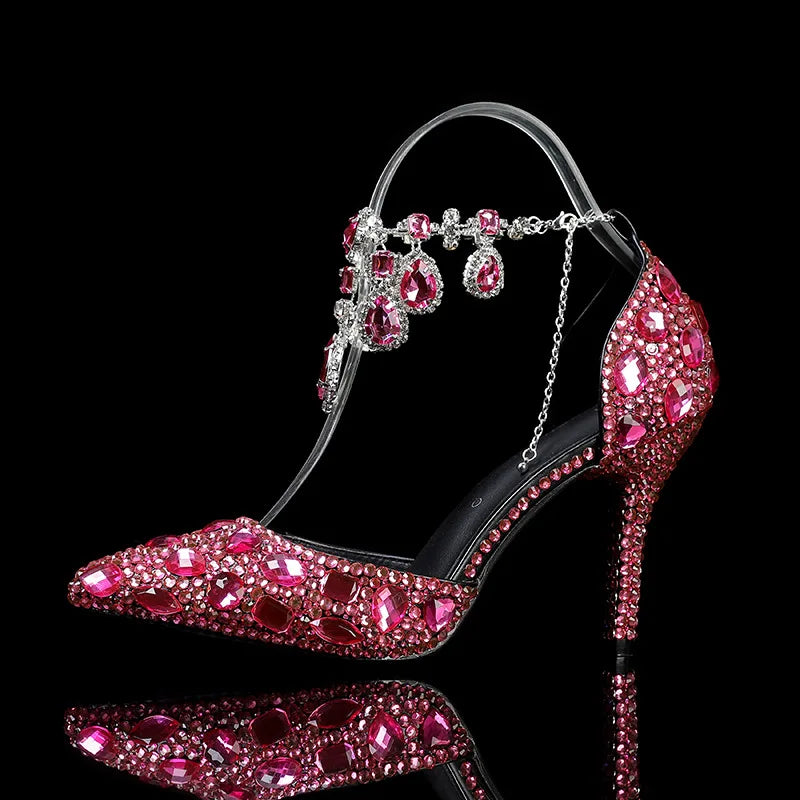 High-heeled shoe with pink gemstones on a black background