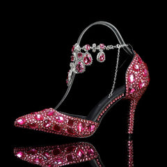 High-heeled shoe with pink gemstones on a black background
