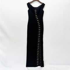Black off shoulder maxi dress with metal buckle detailing displayed on a hanger.