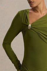 Green dress with long sleeves and a close-up of the neckline on a neutral background