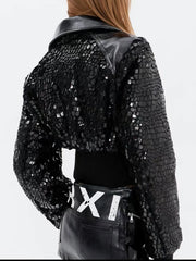 Black sequin jacket with a white 'XI' belt on a plain background
