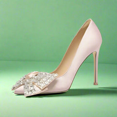 High-heeled shoe with decorative bow on a light gray background