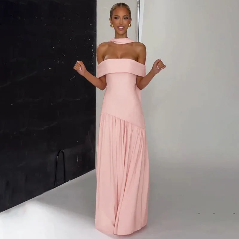 Woman wearing a pink off-shoulder gown against a neutral background