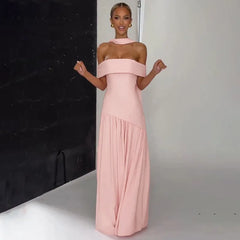 Woman wearing a pink off-shoulder gown against a neutral background