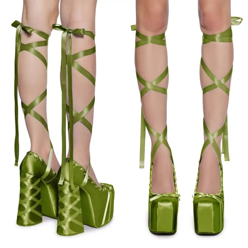 Green platform heels with ribbons on a white background