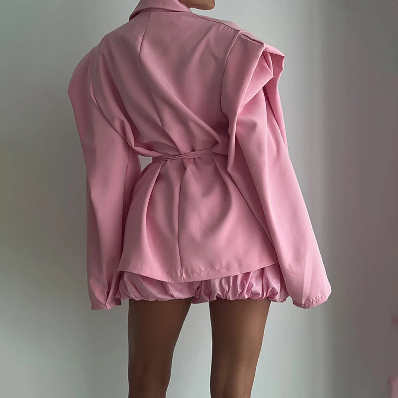 Pink jacket with a belt on a plain background