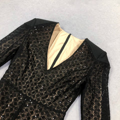 Black sequined jacket with beige lining on a light gray background