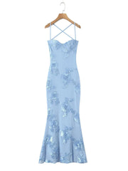 Light blue evening gown with floral lace details on a hanger against a white background