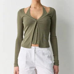 Green long-sleeve top worn by a person on a plain background